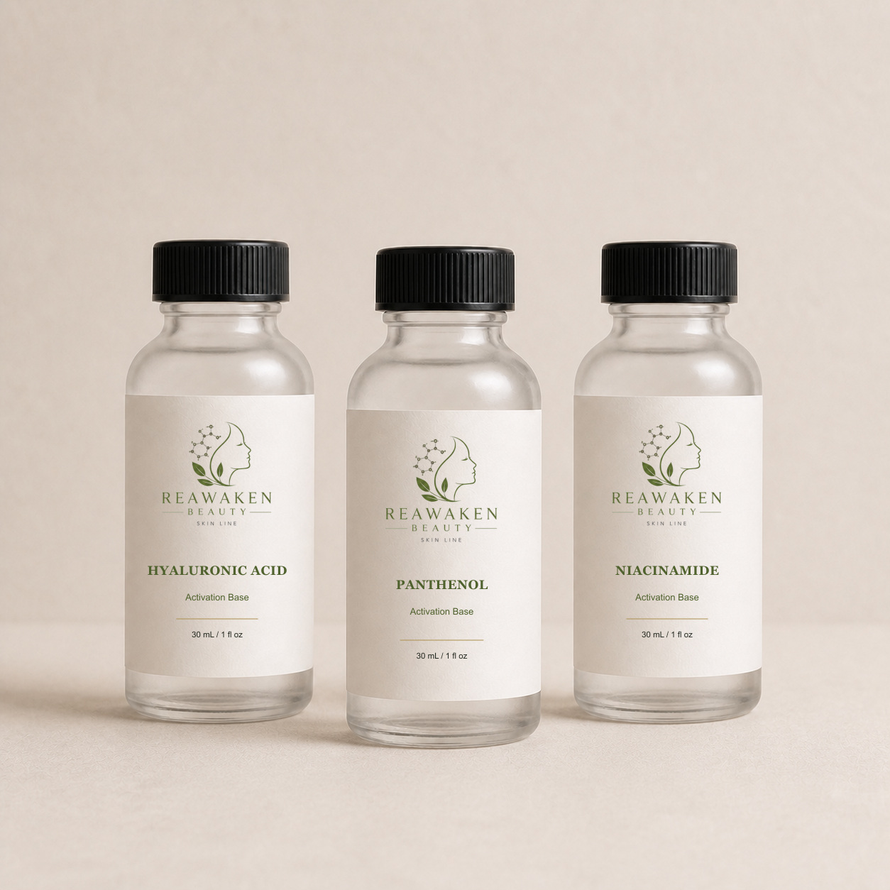 Three matching tall 30 mL Boston-round activation base bottles for hyaluronic acid, panthenol, and niacinamide