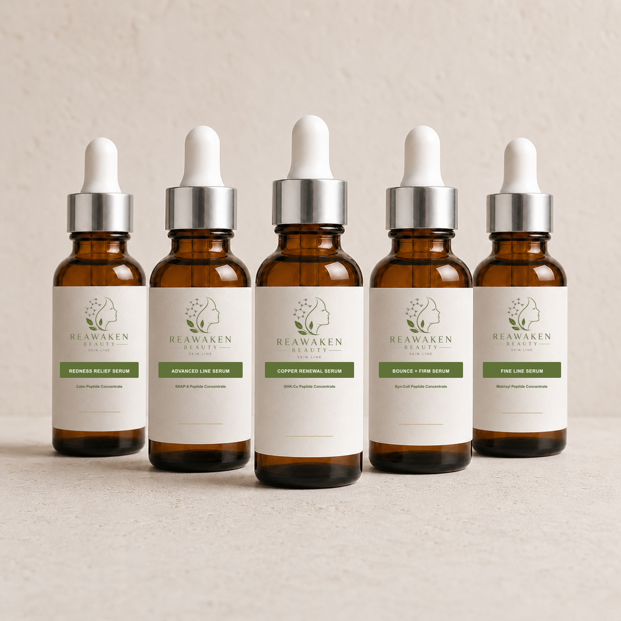 ReAwaken Beauty tall amber 30 mL Boston-round peptide serum lineup